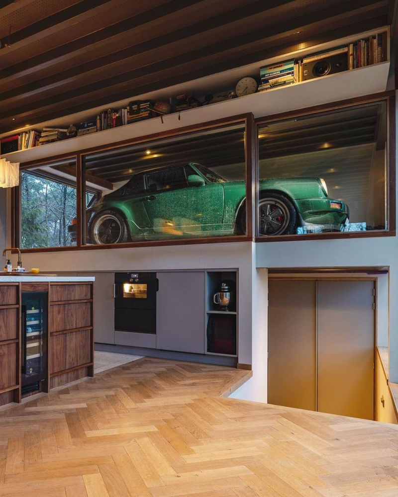 Classic green Porsche in garage window display with views from home kitchen.