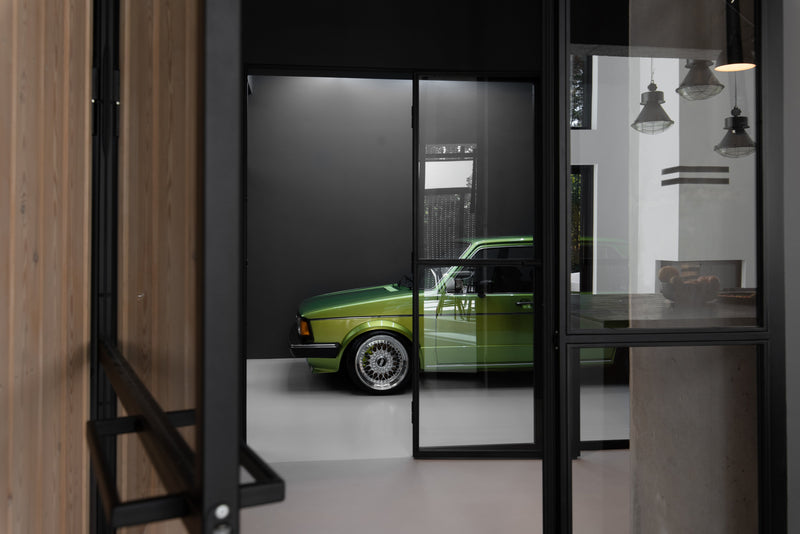 Hilltop House: Love of Mountains and Cars Shapes this Garage