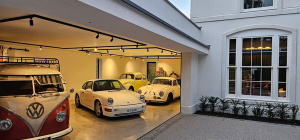 Classic Volkswagen and Porsche collection in pristine garage of classic home in England.