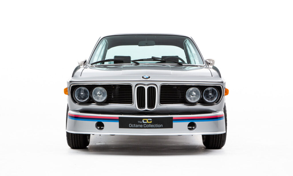 Front view of a classic silver BMW 3.2 CSL Batmobile branding on a white background