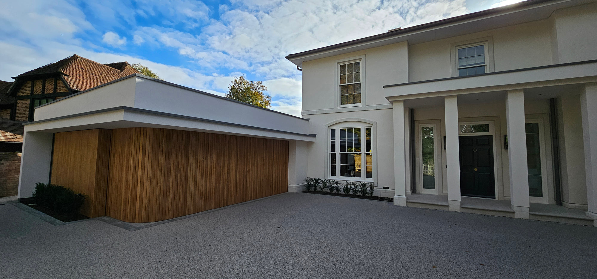 Gulbarg house by NEON Architecture with sliding oak garage door detail.