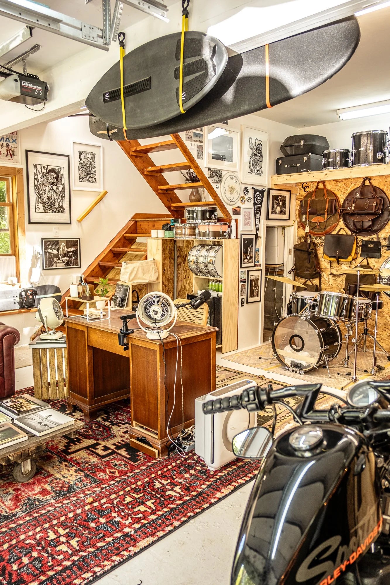 Garage setting with a motorcycle, desk, and various items in a room.