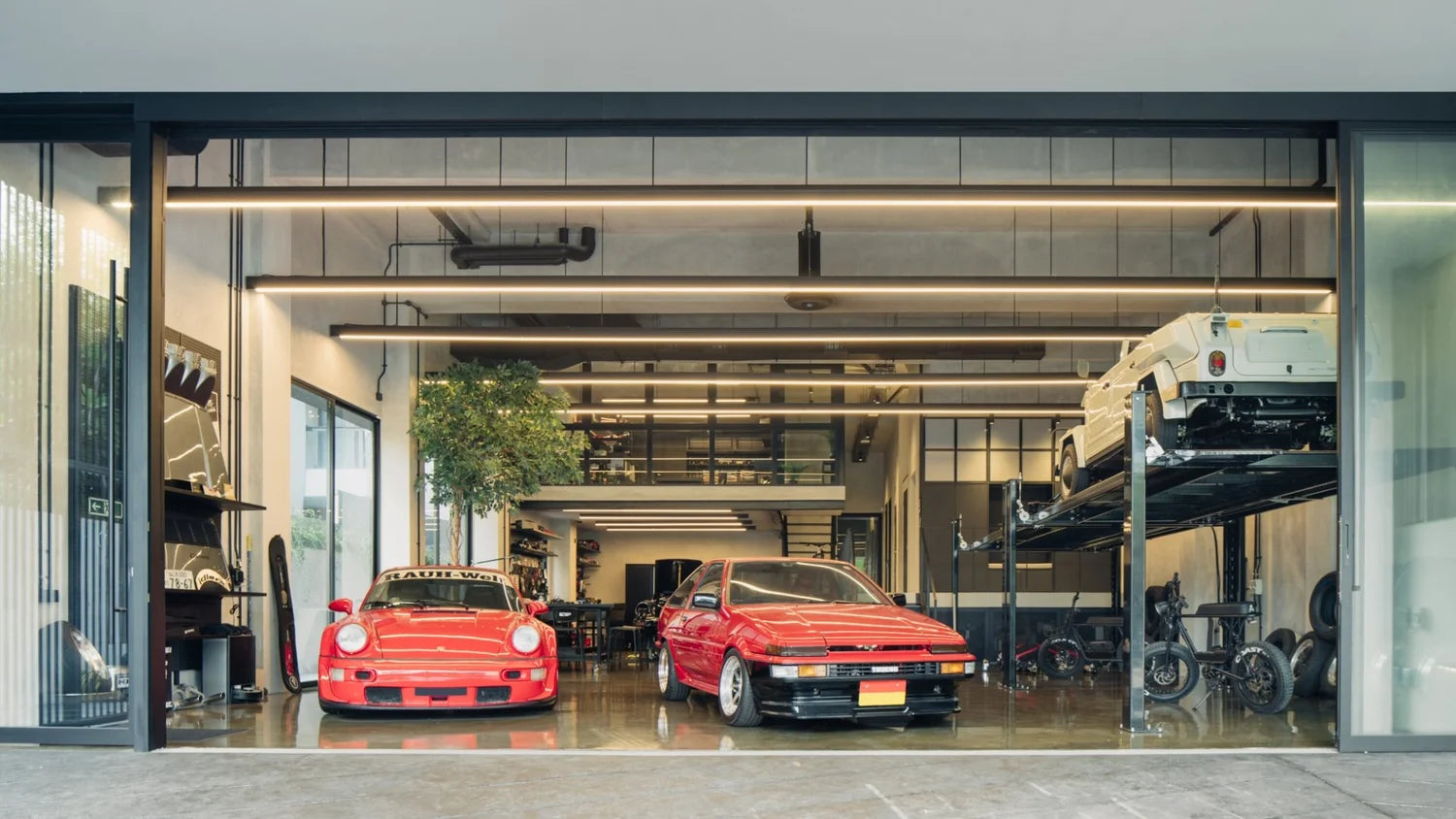 Jansen Tan's Singapore garage house featuring a red Porsche 911, Toyota AE86, and a white Volkswagen Thing.
