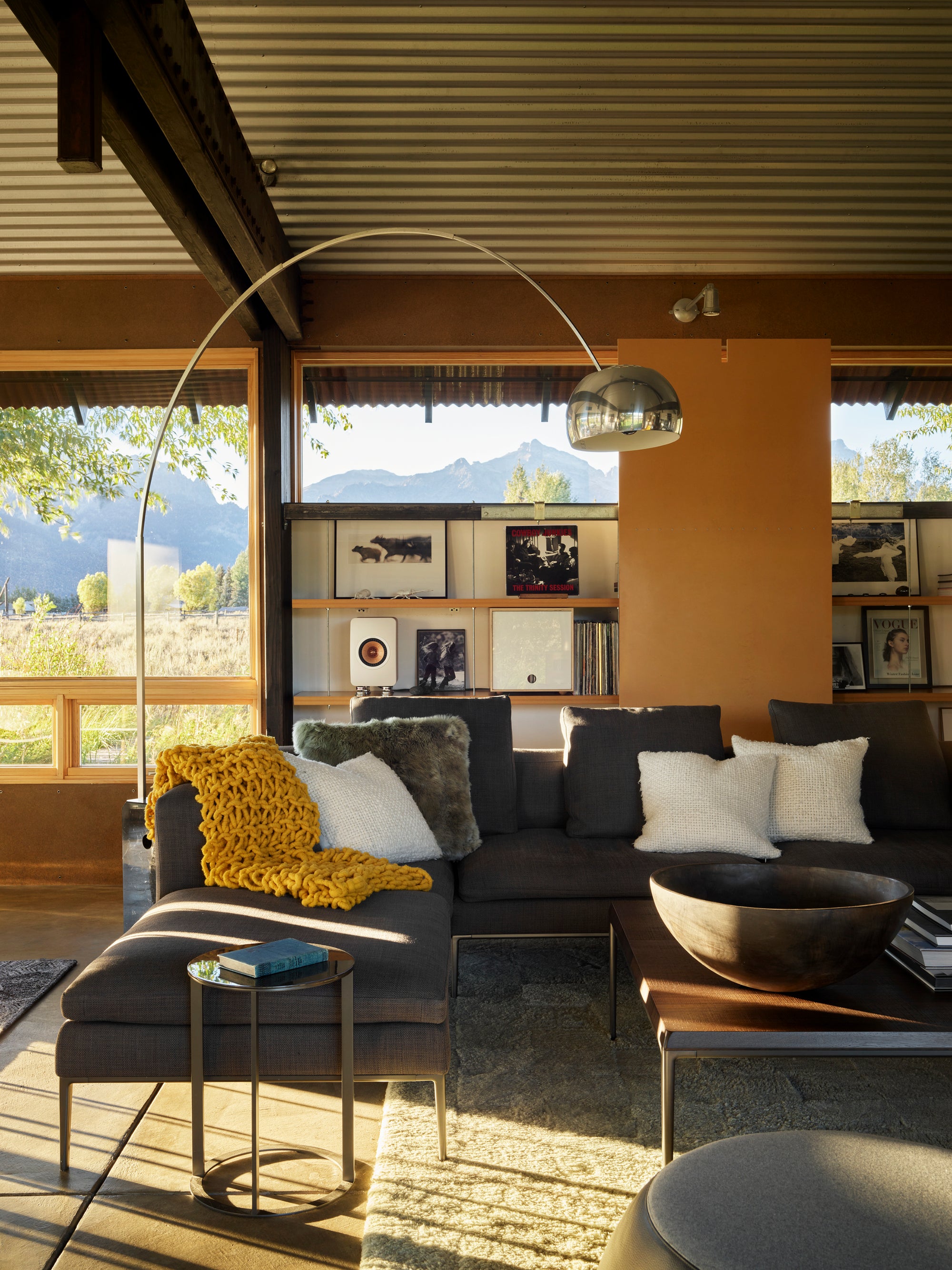 Modern living room in Logan Pavilion, Jackson, WY, with sectional sofa and mountain views.