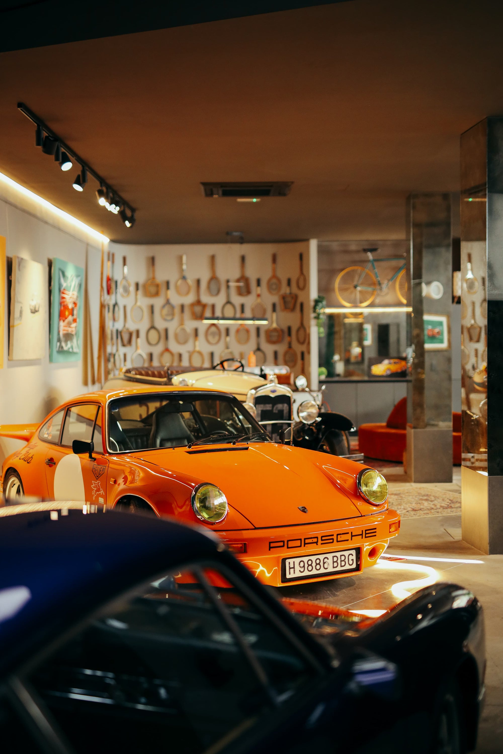 Orange vintage Porsche 911 in Manu Campa's art-filled garage studio in Madrid, Spain.