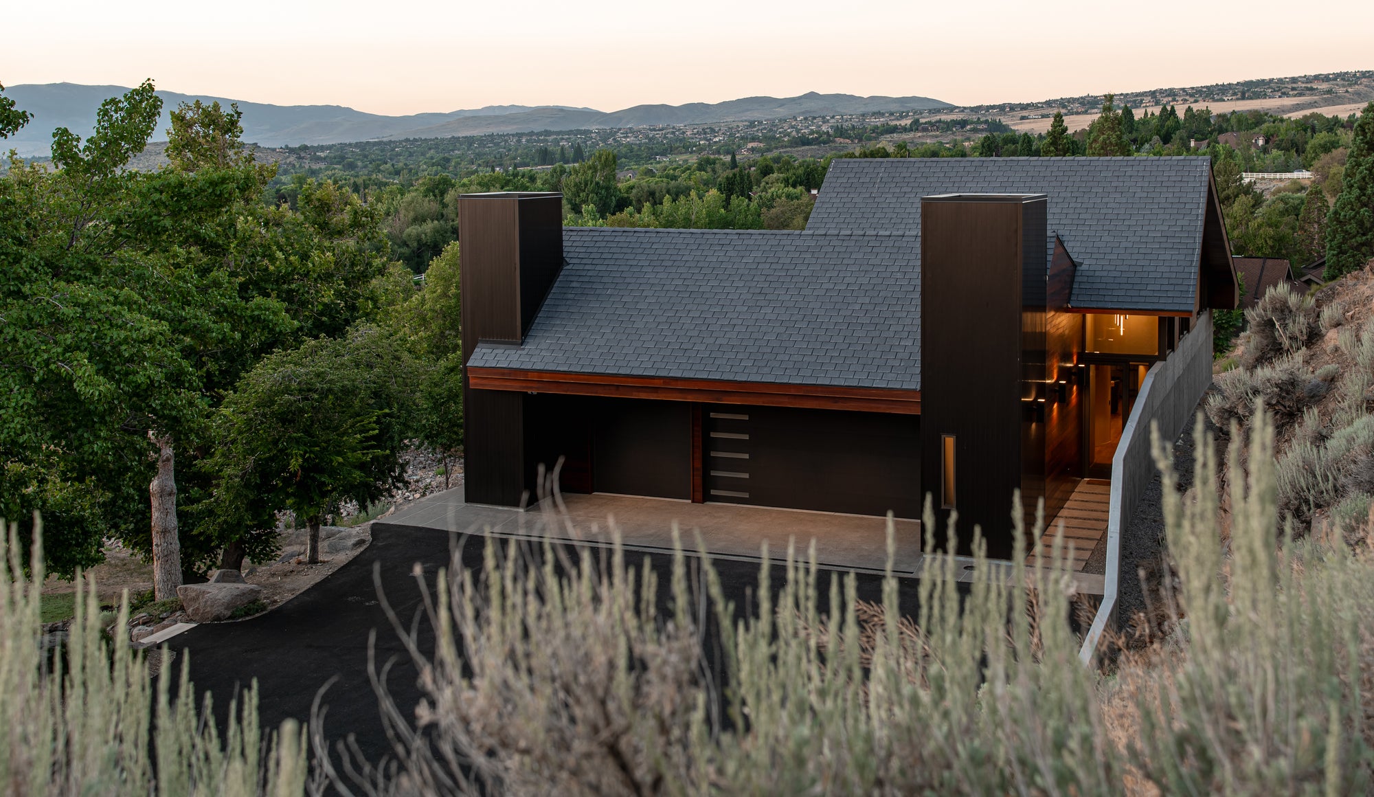 Modern garage exterior with clean driveway design and hillside setting in Nevada