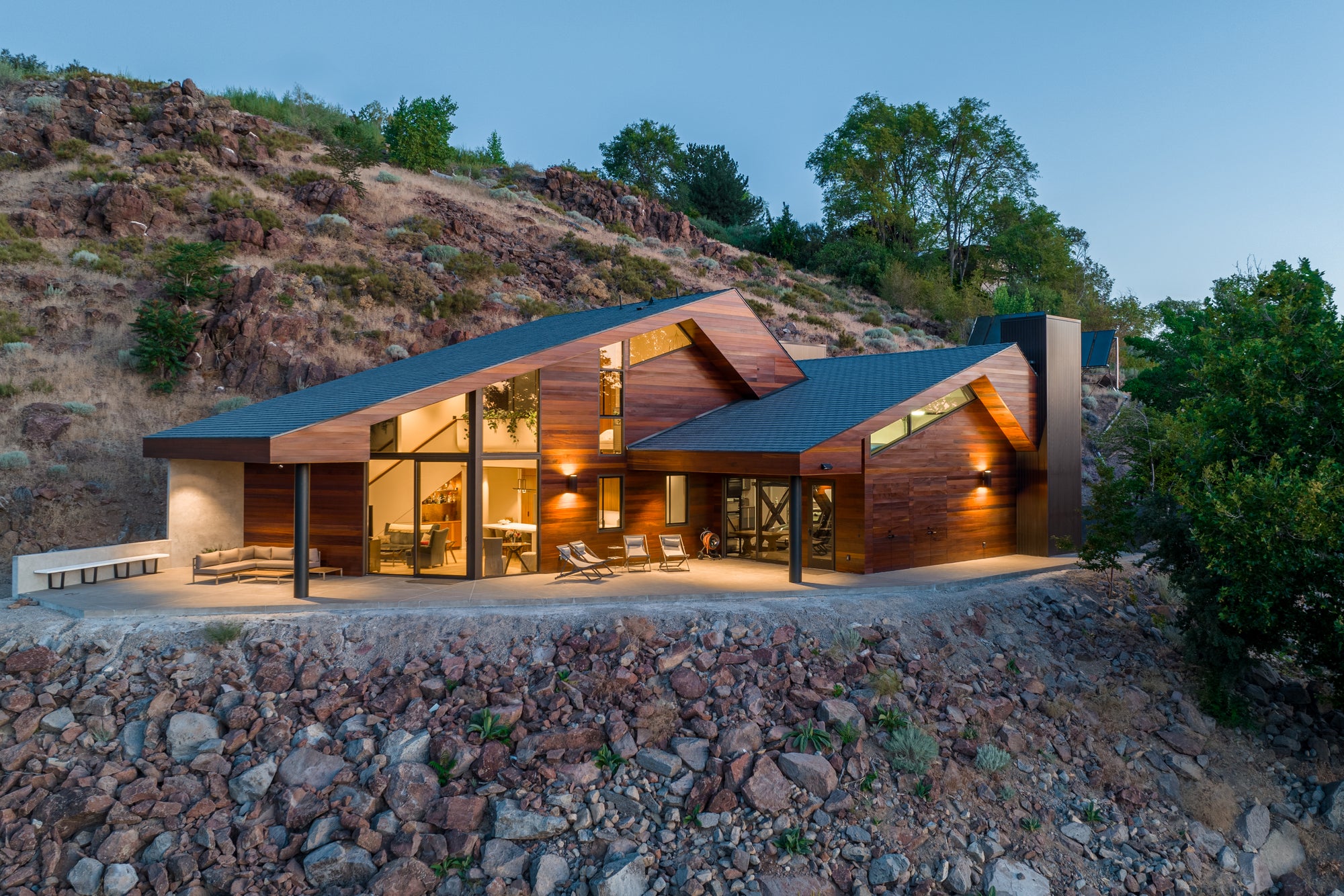 Modern hillside home with integrated garage architecture set into a rocky Nevada landscape