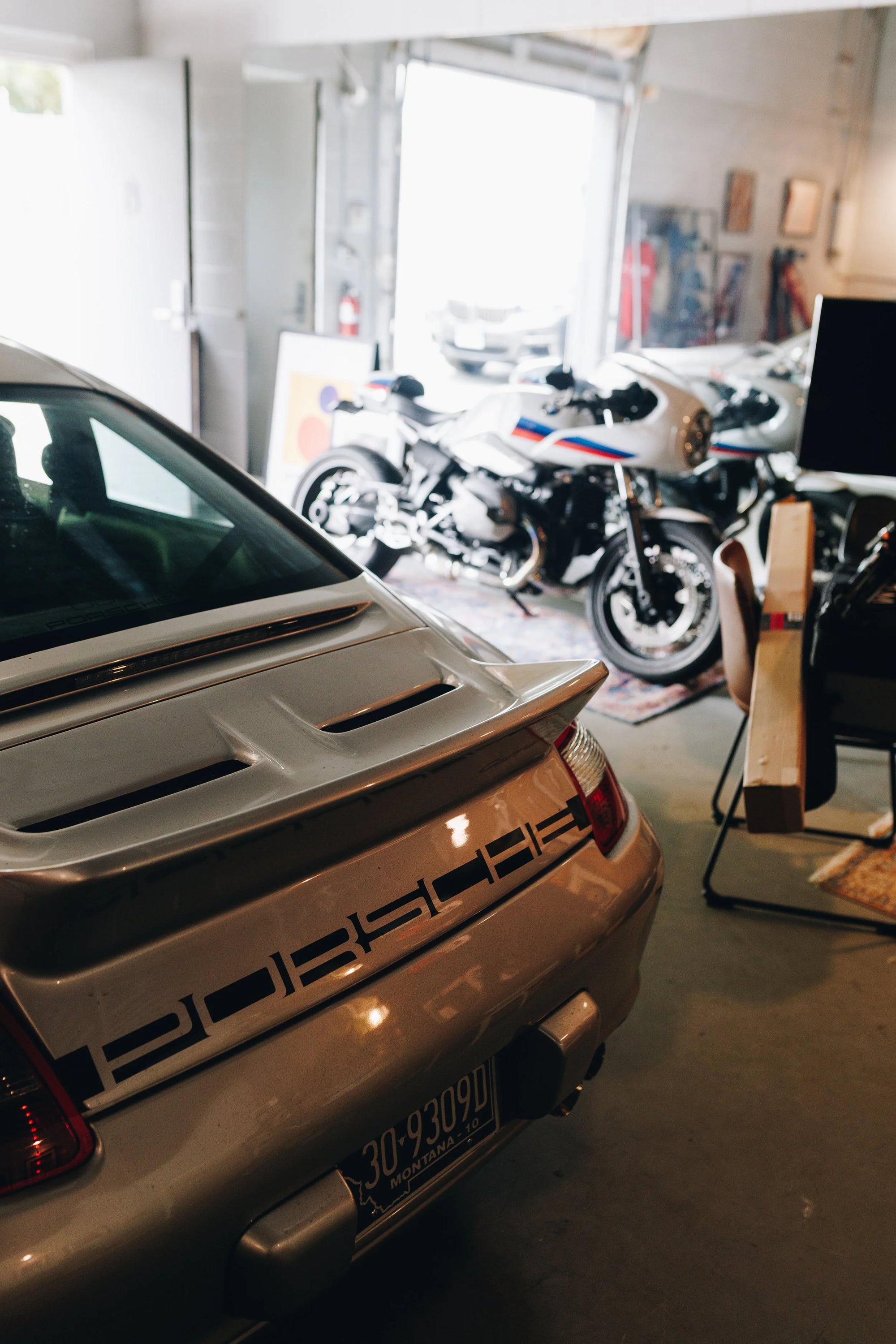 Porsche and BMW motorcycles inside of the Werkstatt 80 garage. 