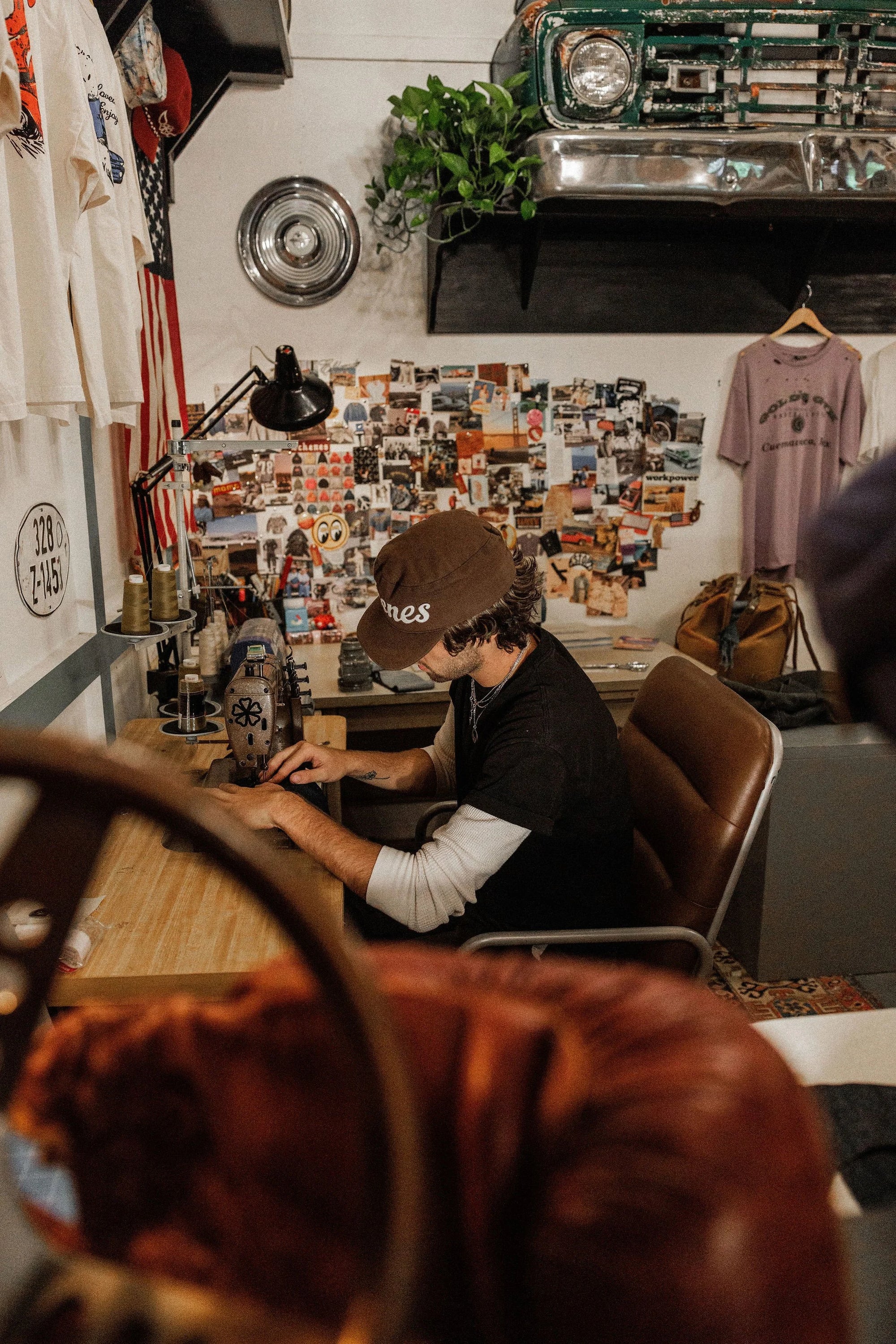 Zander Roe, owner of Schenes, meticulously sewing on a vintage machine in his Northern California workshop.